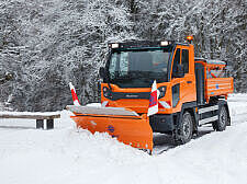 Geräteträger beim Räumen, Bürsten und Pflügen von Schnee im Winterdienst.